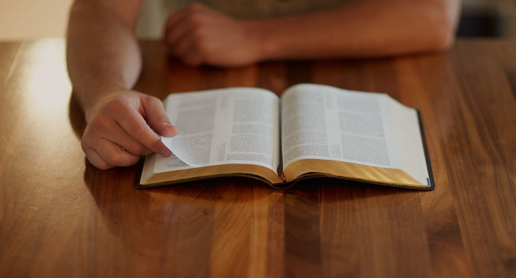 Bible on Table in Dimmer Light